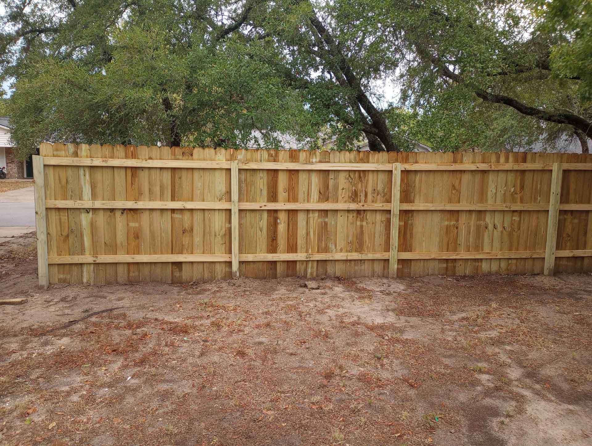 A newly installed wooden backyard fence