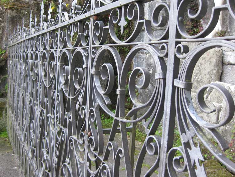 A weathered wrought iron fence