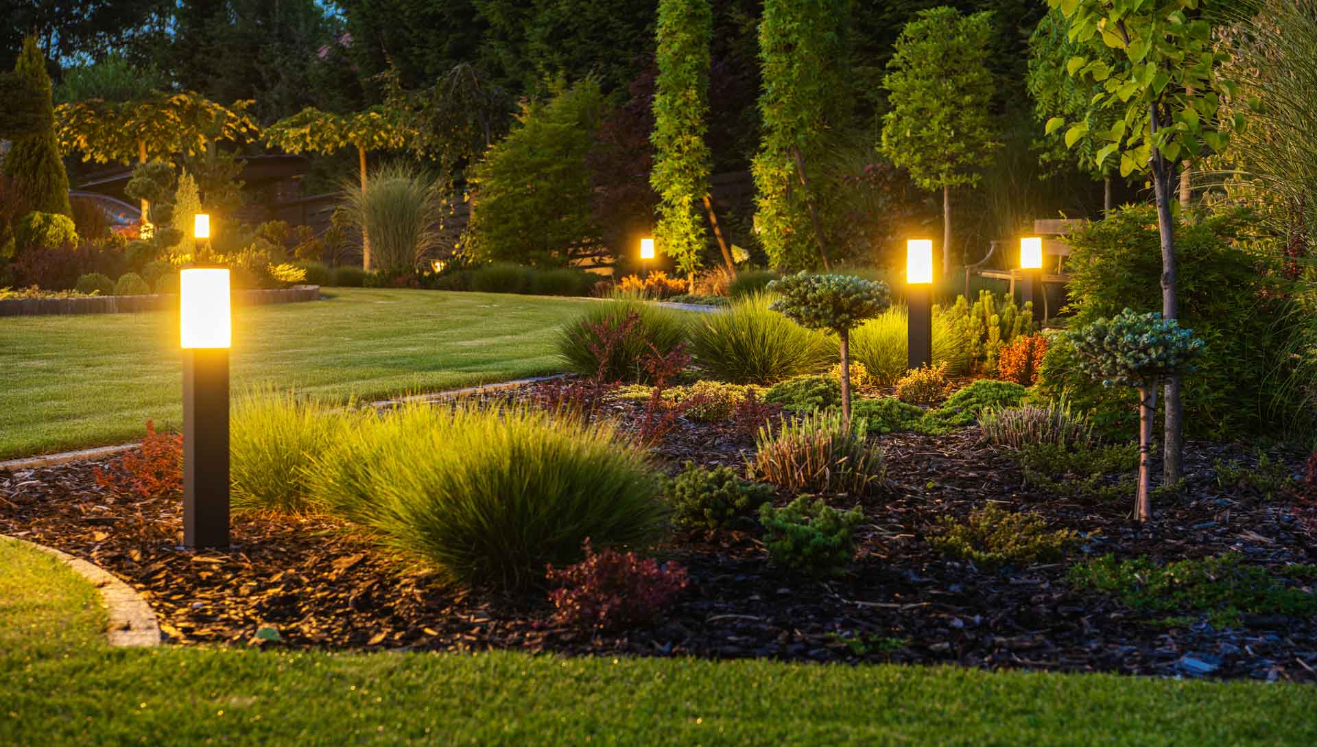 Beautifully landscaped flowerbed at dusk
