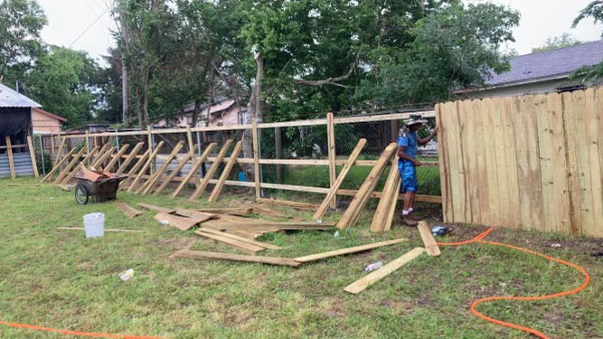 In-progress wooden fence installation